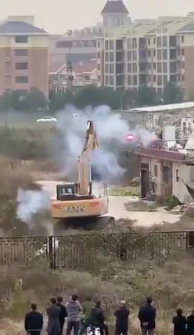 Man in China uses fireworks to fight off bulldozer sent to demolish his building