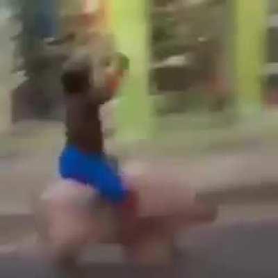 a kid riding a pig