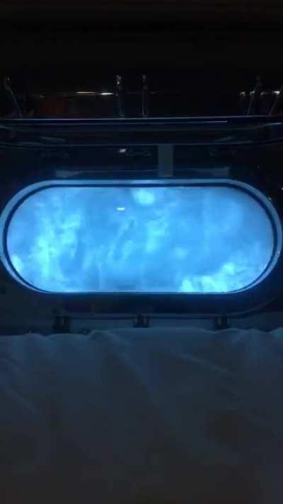 OC Porthole view while sailing off the Amalfi coast