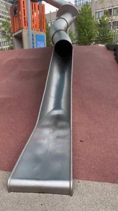 Policeman using a park slide...