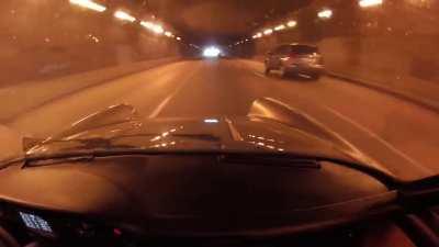 Porsche 911 Turbo money shifts inside a tunnel.