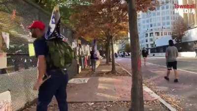 Trump supporters tear down signs they don't agree with outside the White House.