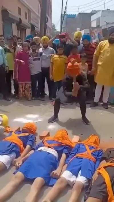 Smashing bricks between heads while being blindfolded