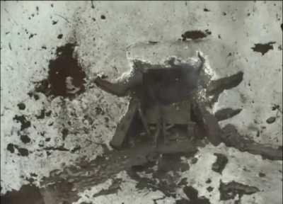 A Ukrainian FPV drone hits a Russian dugout. Four dazed Russian soldiers stumble out, some of them wounded.