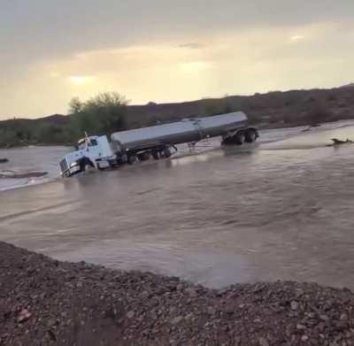 Semi-truck drives straight into flood waters