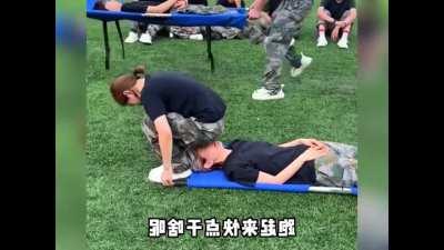 To pick up a stretcher with your teammate on it.