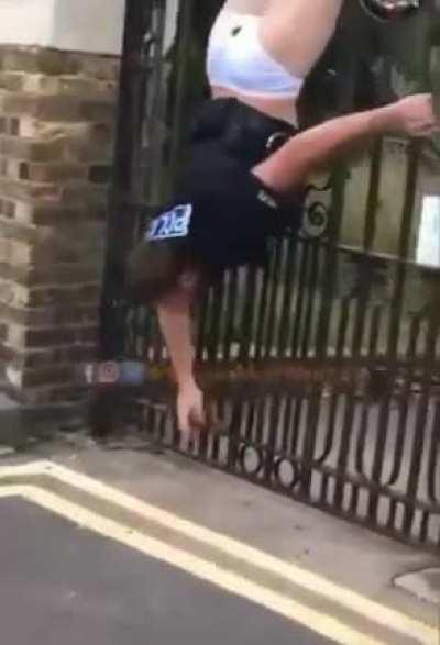 police man caught on a fence