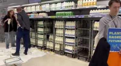 UK activists pouring milk in Supermarket to stop Oil & Gas and to have a PlantBasedFuture