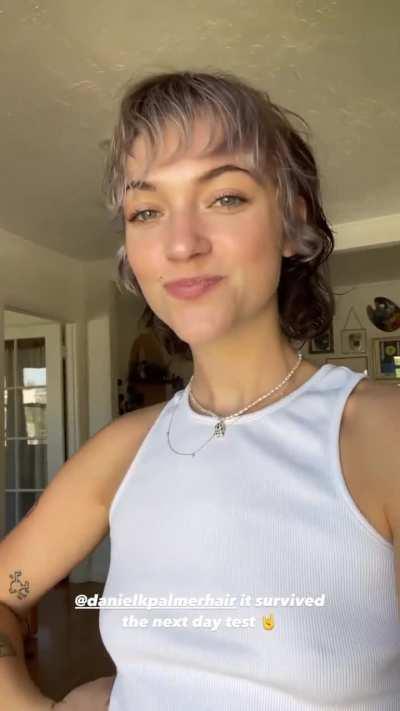 Playing with her new haircut