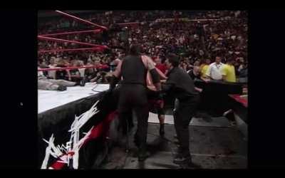 The Undertaker nonchalantly saves Shane McMahon from a flying beer then proceeds to knock him out