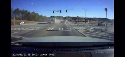 An 18-wheeler hauling 78,000 pounds of gravel speeds through a red light and smashes into a 78 year old woman driving an SUV. The woman suffered a few bruises and was shaken up, but no severe injuries.