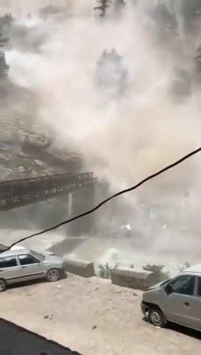 Rolling boulders from an adjacent hill destroys a bridge in the Indian state of Himachal Pradesh in July 2021. Nine people were reported dead.