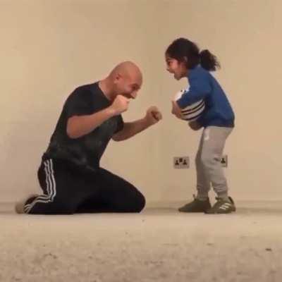 Girl finally masters soccer trick and both dad and girl are ecstatic