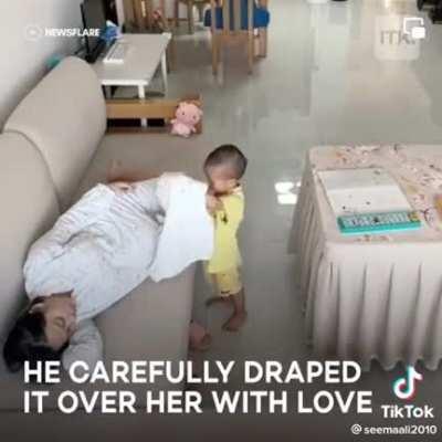 Toddler caring for his pregnant mother