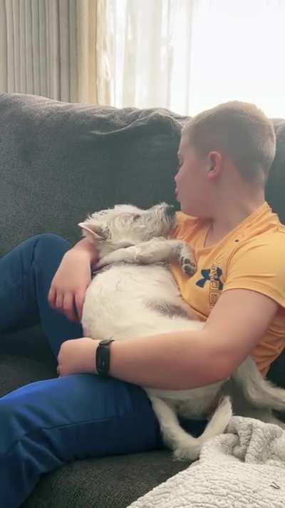 A boy singing to his dog.