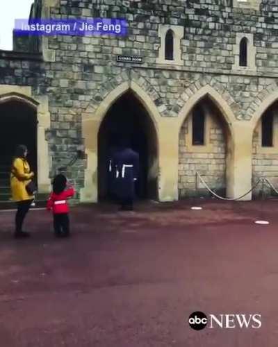 Windsor Castle soldier salutes little boy dressed as a British Guard