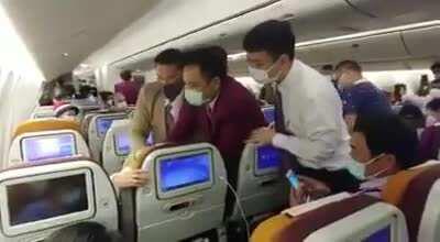 Chinese woman coughs on a stewardess on Thai airlines