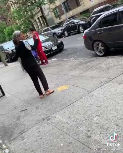 Woman who was previously filmed being racist to two women who dropped their phone charger is seen again in NYC. The crowd recognizes her and isn’t kind...