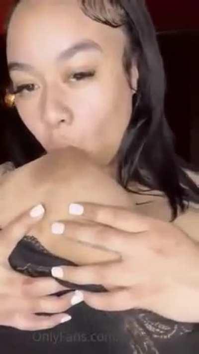 Sucking her own boobs