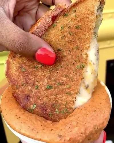Grilled Cheese sandwich dipped in creamy tomato sauce