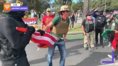 Flag altercation at Beverly Hills Trump rally man uses flag to defend himself then gets jumped by Antifa/BLM before police intervene - 31th October