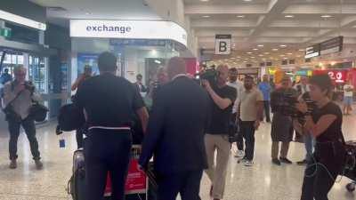 Patty carrying 1.4billions hopes on a trolley after landing in AUS