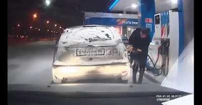 Woman uses lighter on frozen gas tank; lights gasoline