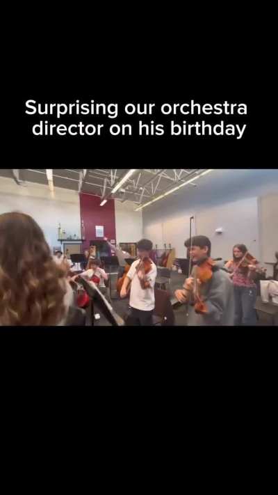 In middle of practice, orchestra surprises their director with birthday music