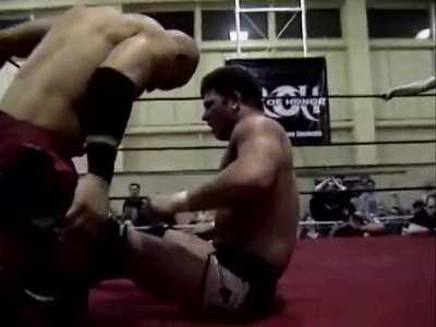 AJ Styles hits Low Ki with a DDT from a crucifix powerbomb.