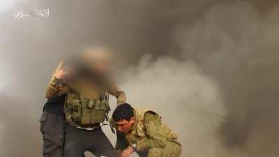 Hamas break through the separating barrier near Khan Yunis and targets a nearby tank, imprisoning the soldiers in it.