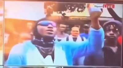 Kenyan Protester smoking tear gas from a canister thrown at him by the Anti-Riot Police in the ongoing protests 