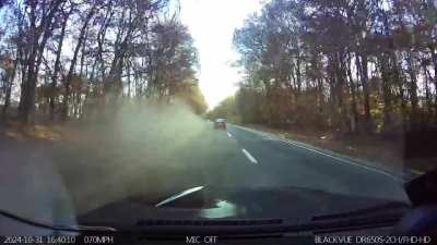 Idiot drives up onto the grass to pass everyone on a busy highway; destroys car