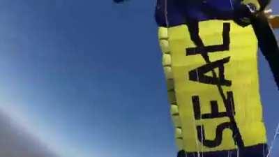 Navy SEALS parachute into football stadium