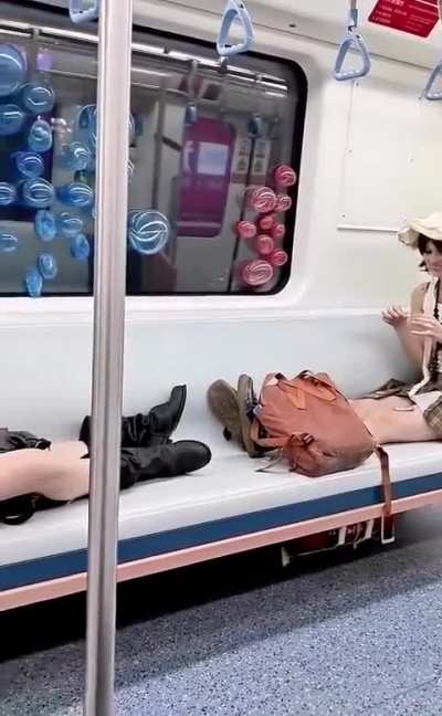 Two girls on a metro in Shanghai