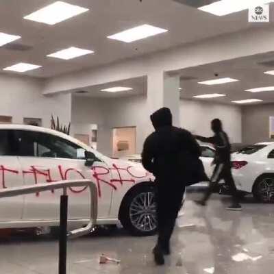 Rioters broke into a Mercedes dealership, set the cars on fire