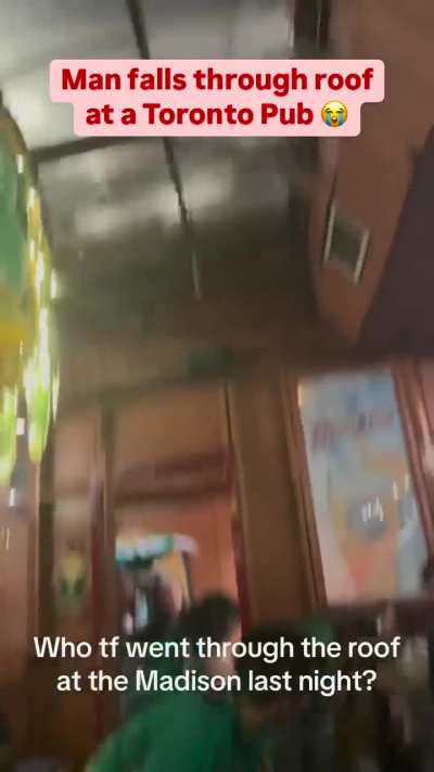 Crowd surprised when man falls through roof of pub