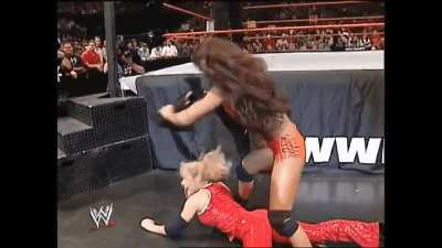 Gail Kim chokes Trish Stratus with Trish's own jacket