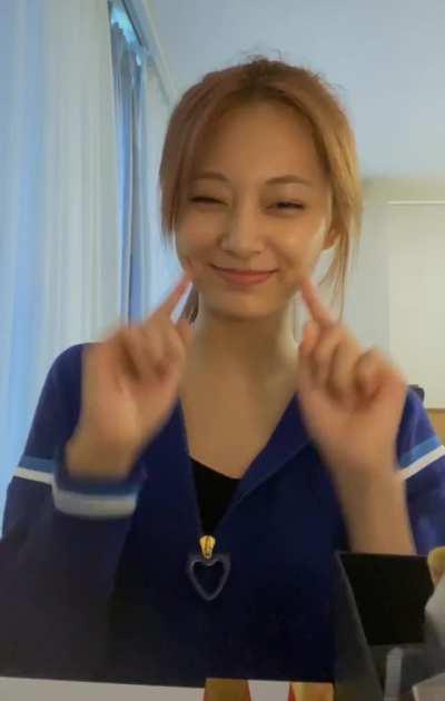 Tzuyu pokes her dimples and winks
