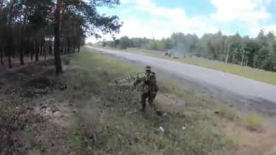 ua pov - Ukrainian SOF, who are inside Russian held territory in a wooded area, find and ambush a car driving on the road adjacent to them, once they confirm the kill, they quickly retreat. SPD company of the separate center 