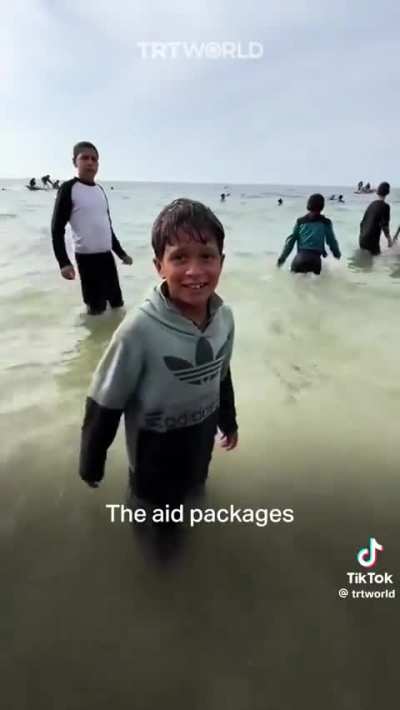 Heartbreaking scenes from Gaza as children wade into the Mediterranean to salvage aid dropped by Jordan, illustrating the desperate need for humanitarian assistance.