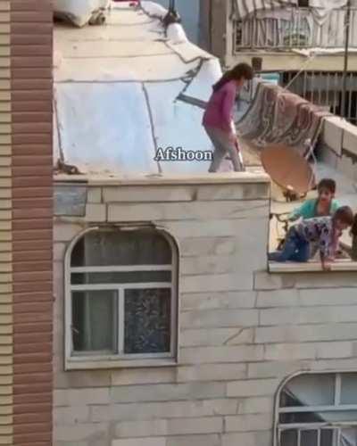 Kids playing on the edge of the rooftop