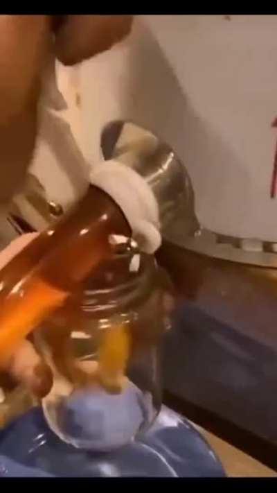 filling up a glas of honey..