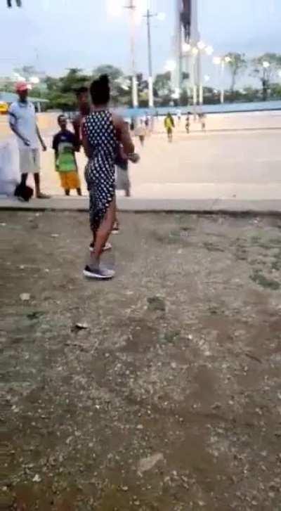 Woman ragdoll a guy in a street fight