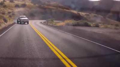 Truck attempts to drift and falls off the side of the road
