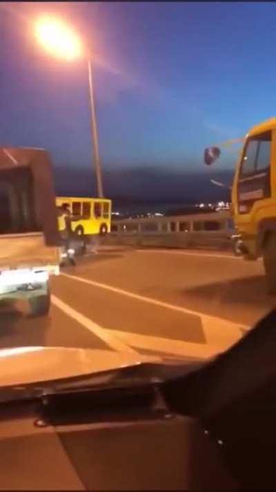 Four people dressed as a bus try to cross a vehicle only bridge