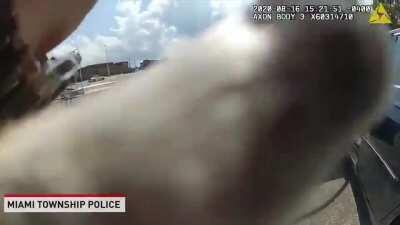 Dog being saved from hot car by police officer