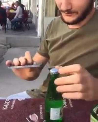 Attempting to open a bottle with a phone