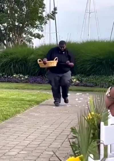 Flower boy doing a perfect job at cousin's wedding