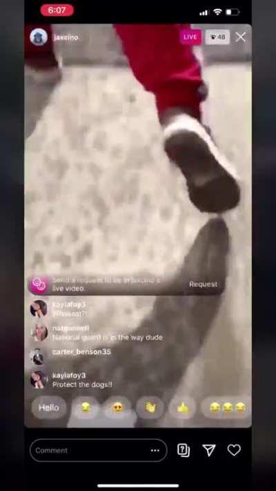 Man points Bow & Arrow at Protesters