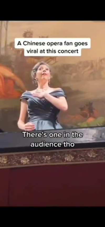 An audience member joins in at the male tenor part of an opera concert.